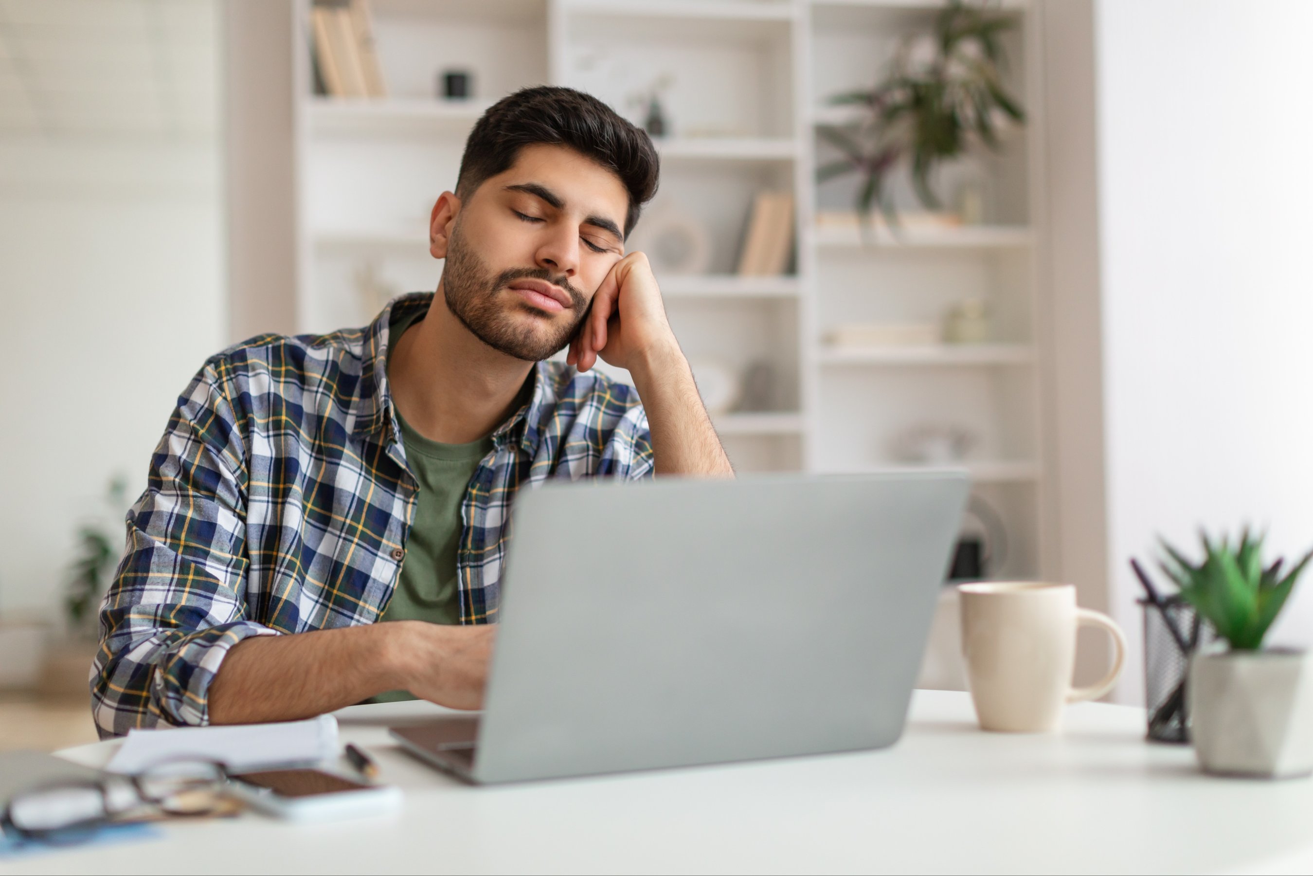 Tired Young Man Sleeping At Work