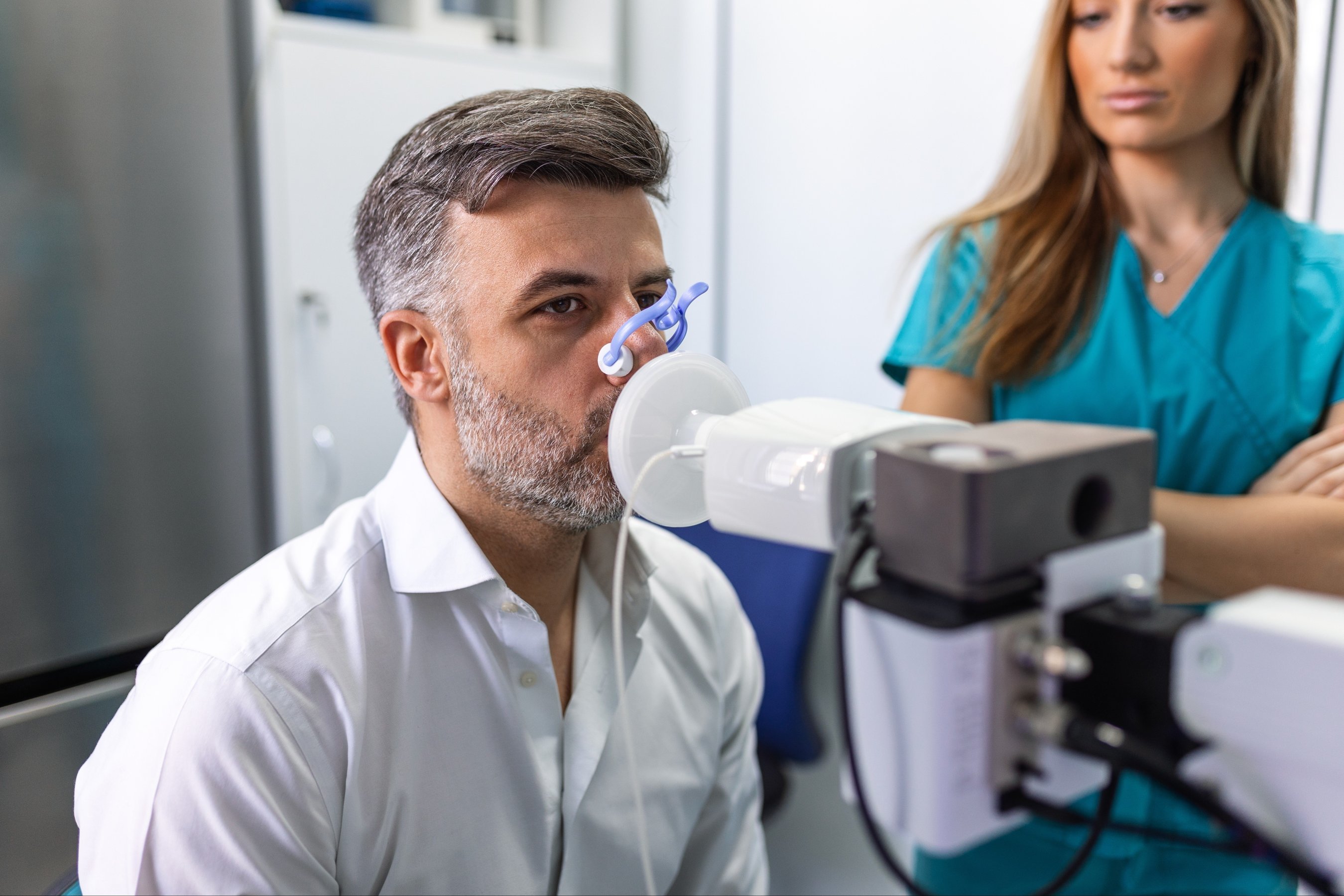 man testing breathing function by spirometry having health problem