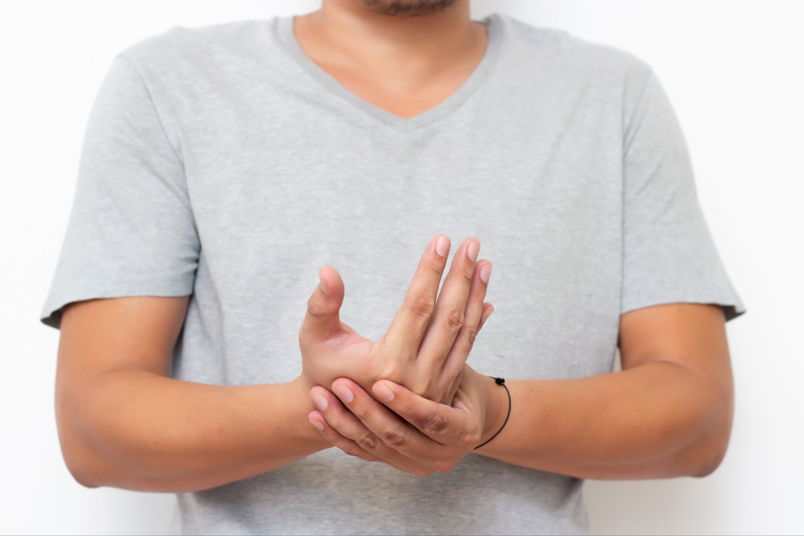 Holding hand man with pain in muscles and joints