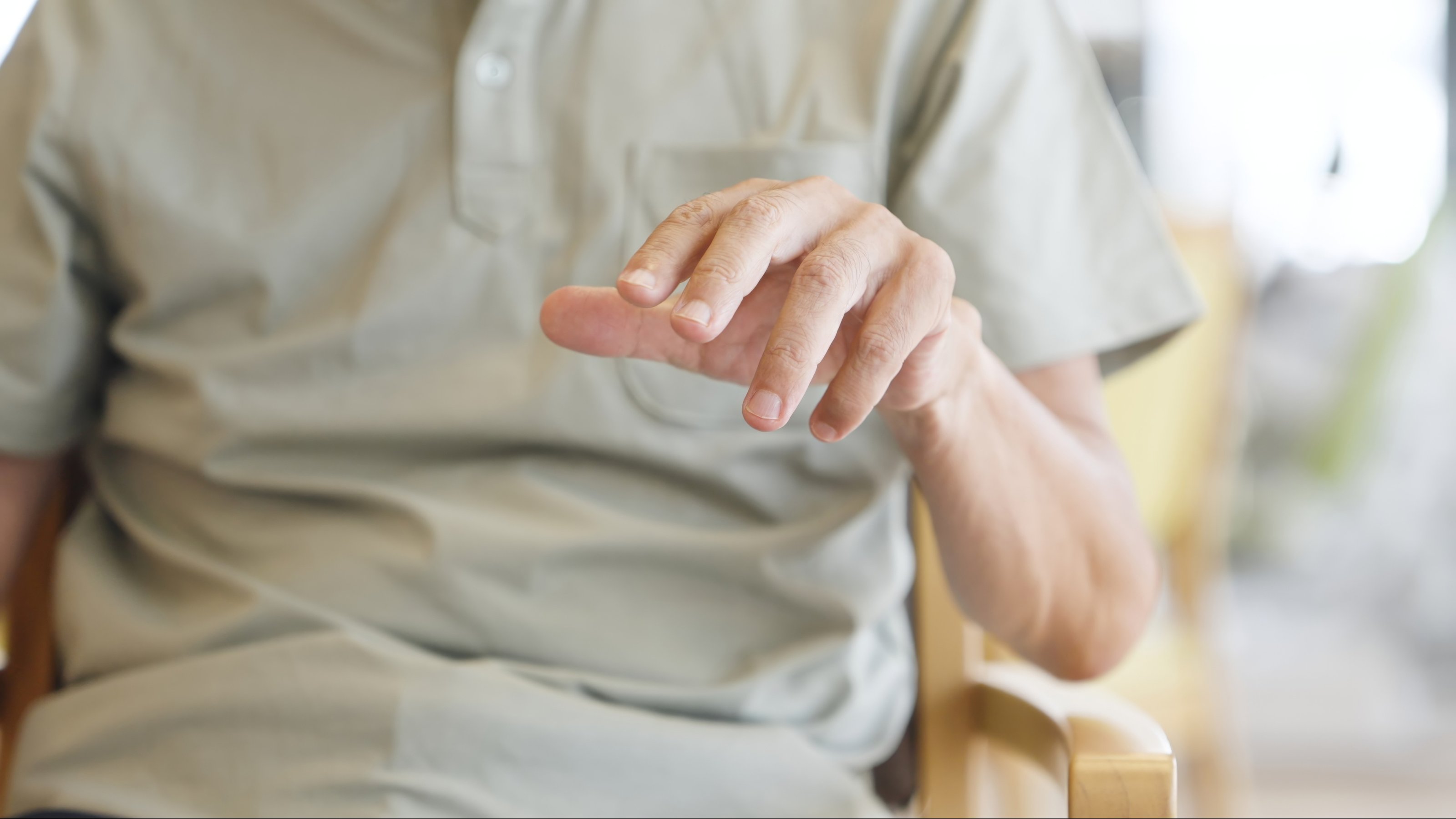 man with trembling hands due to Parkinson disease