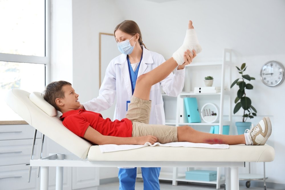 A foot and ankle surgeon examining a patient