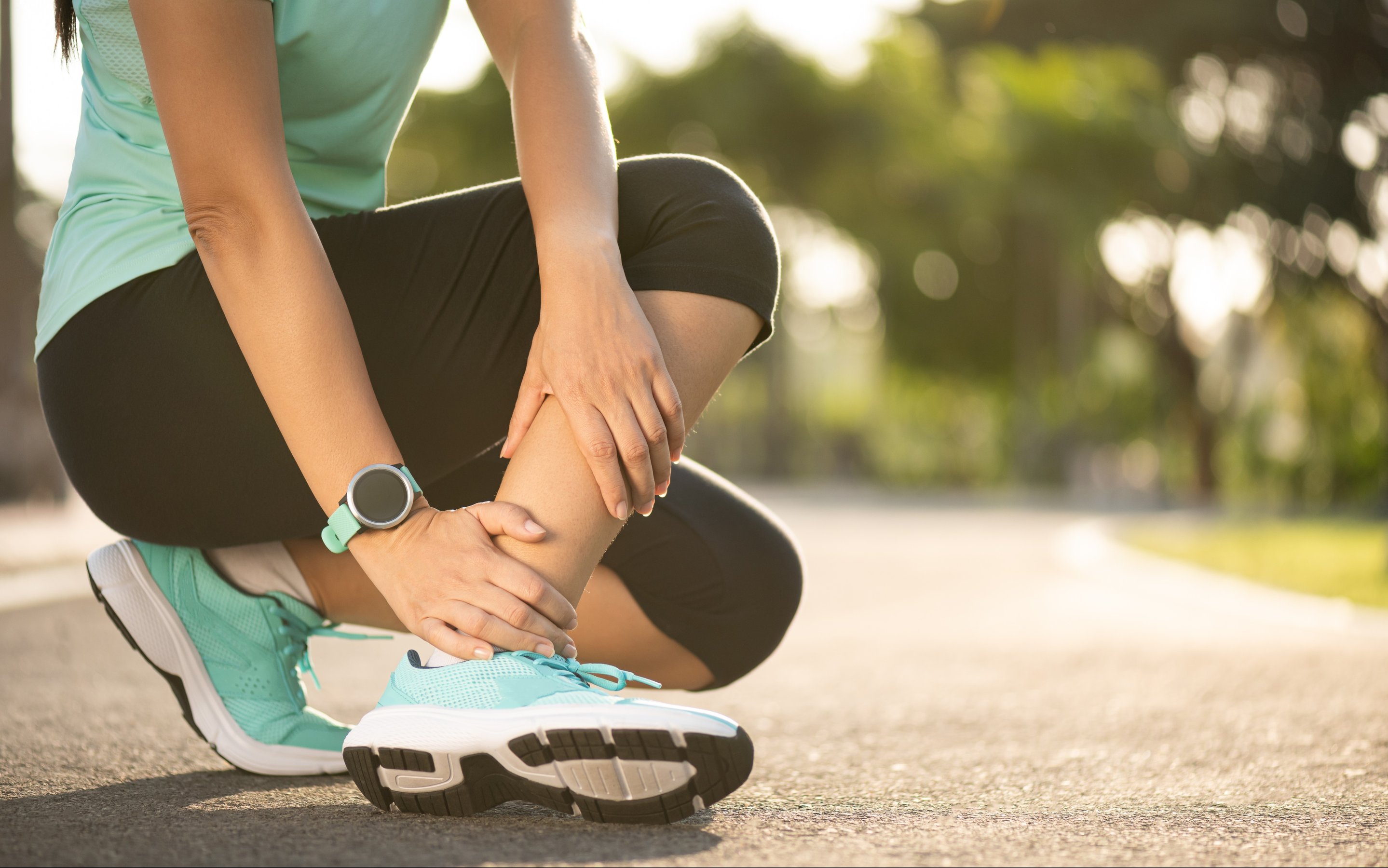 woman suffering from an ankle injury while exercising and running