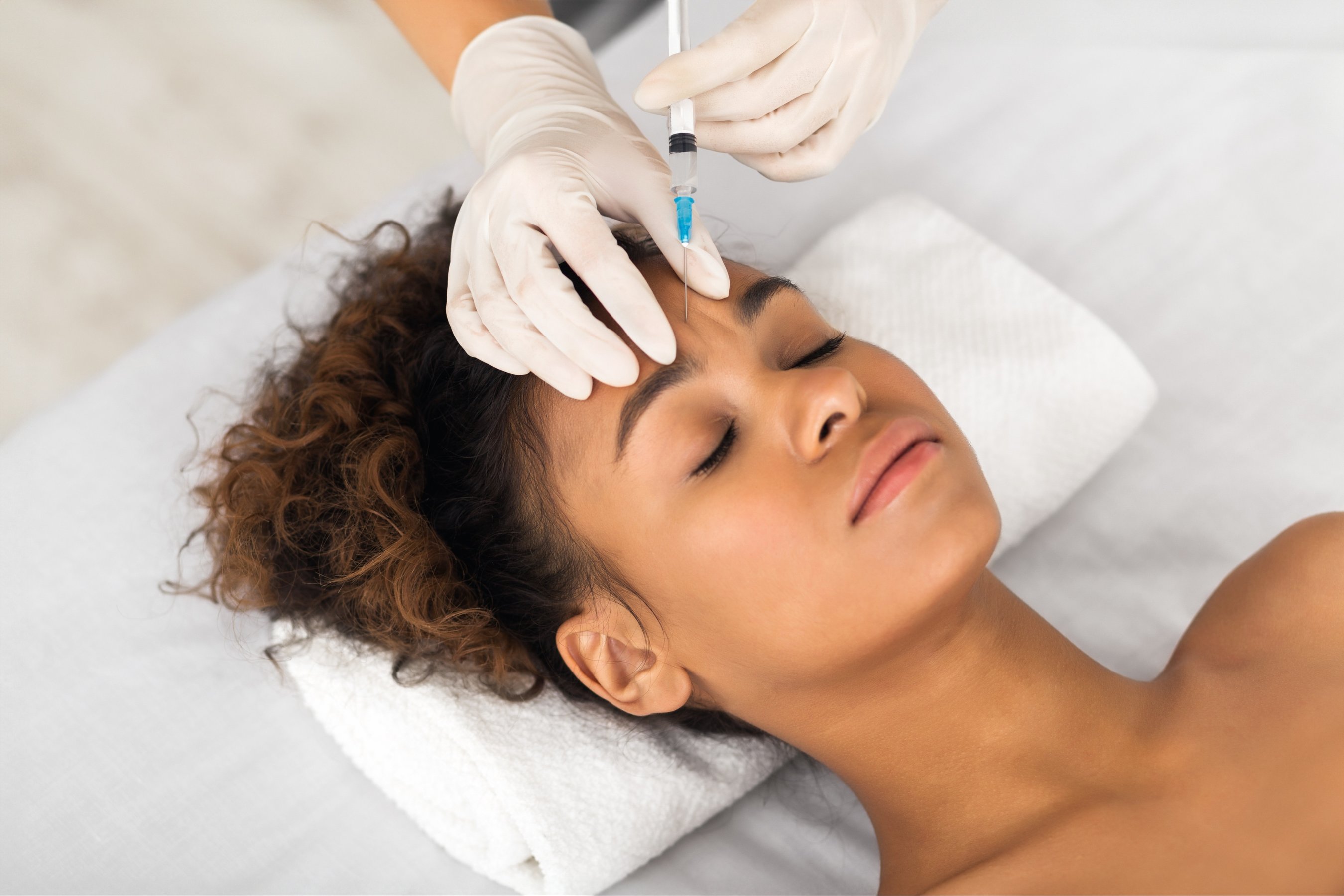 woman patient is receiving a cosmetic injection treatment