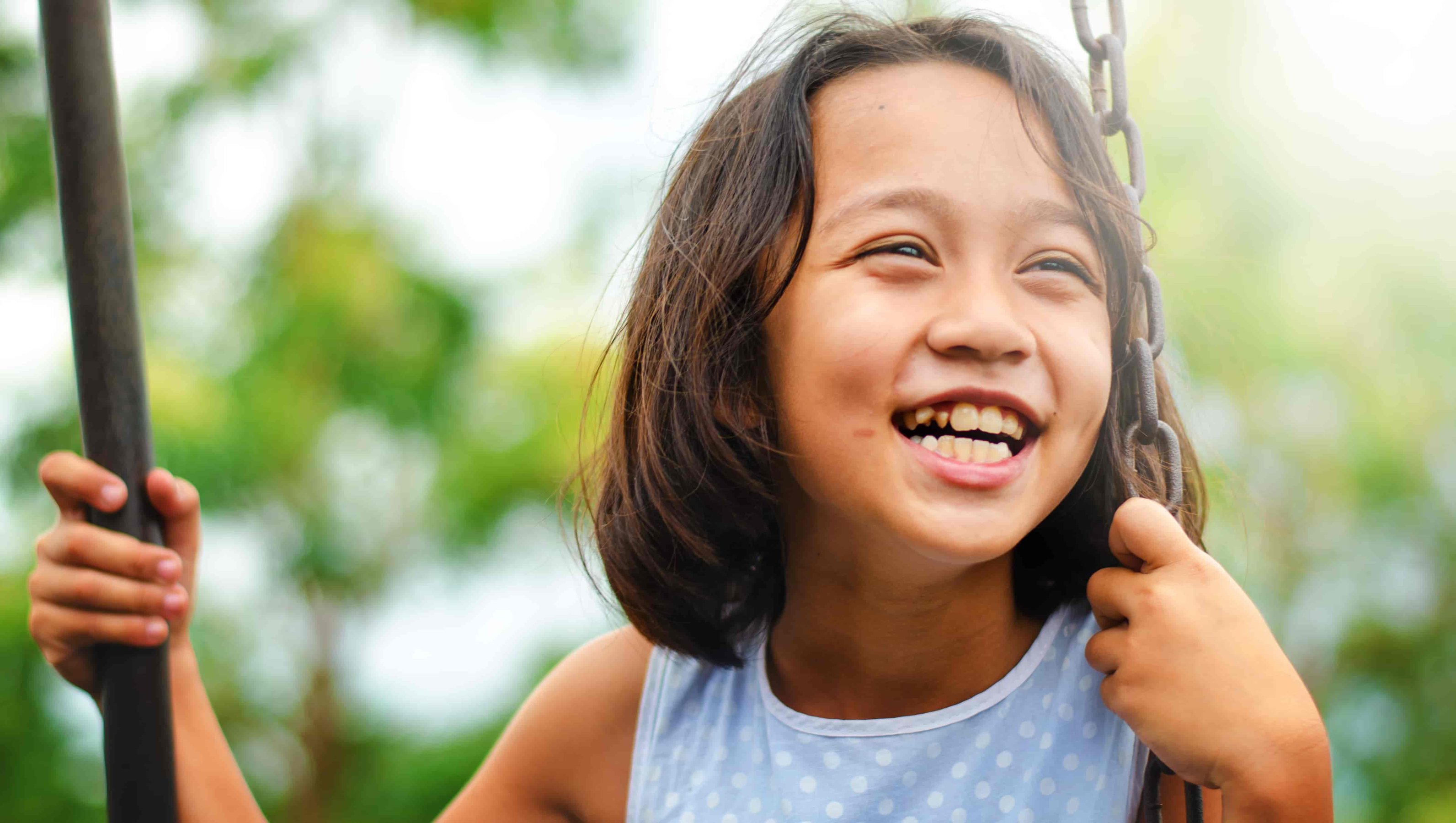 Happy girl swinging