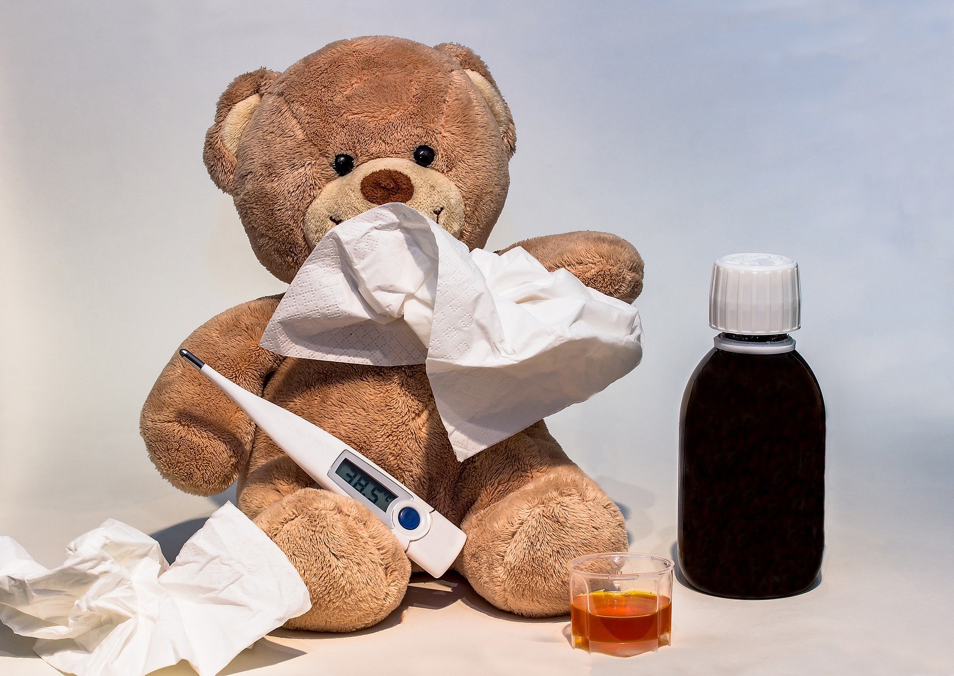 a teddy bear with flu medicine