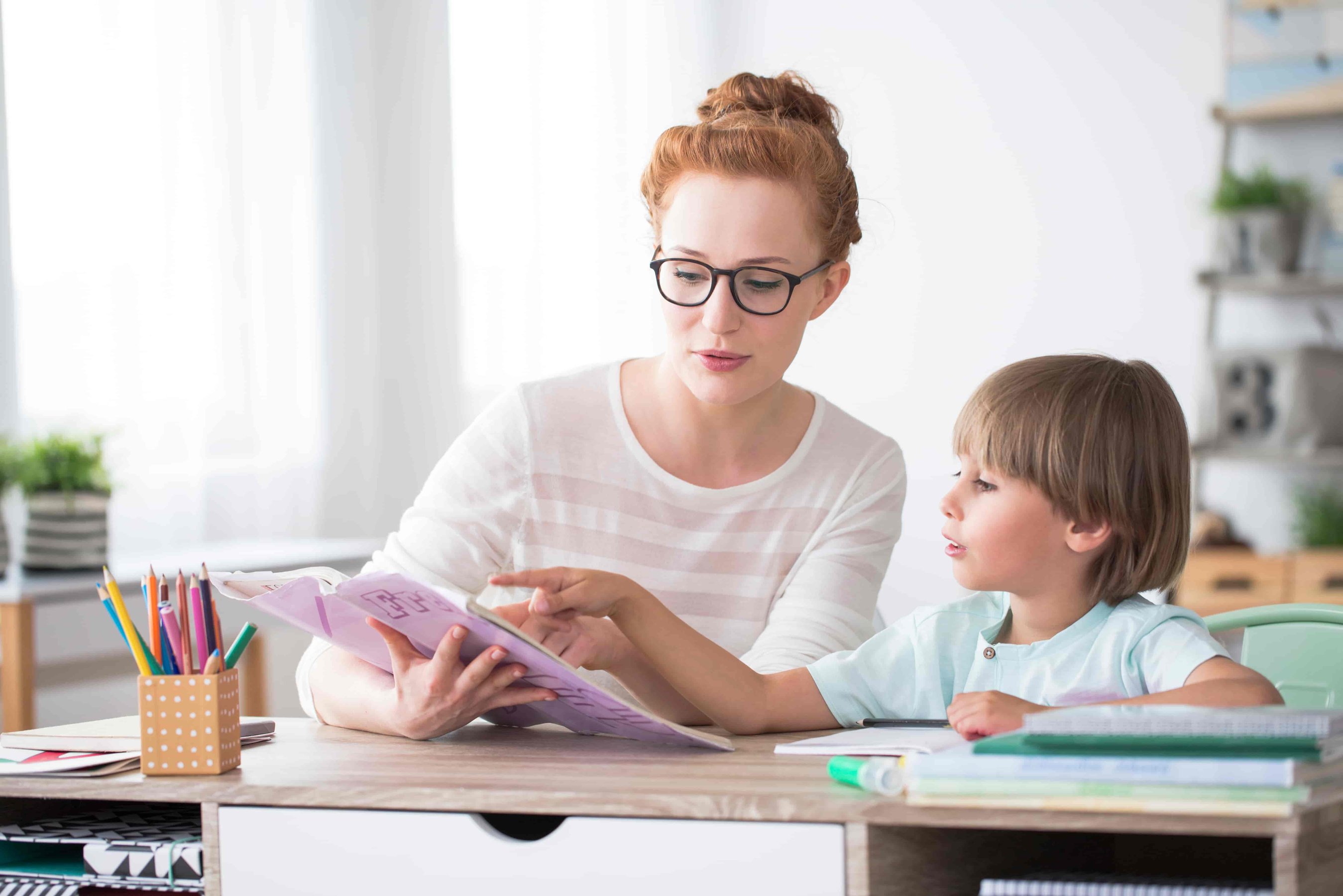 Boy studying with his mother