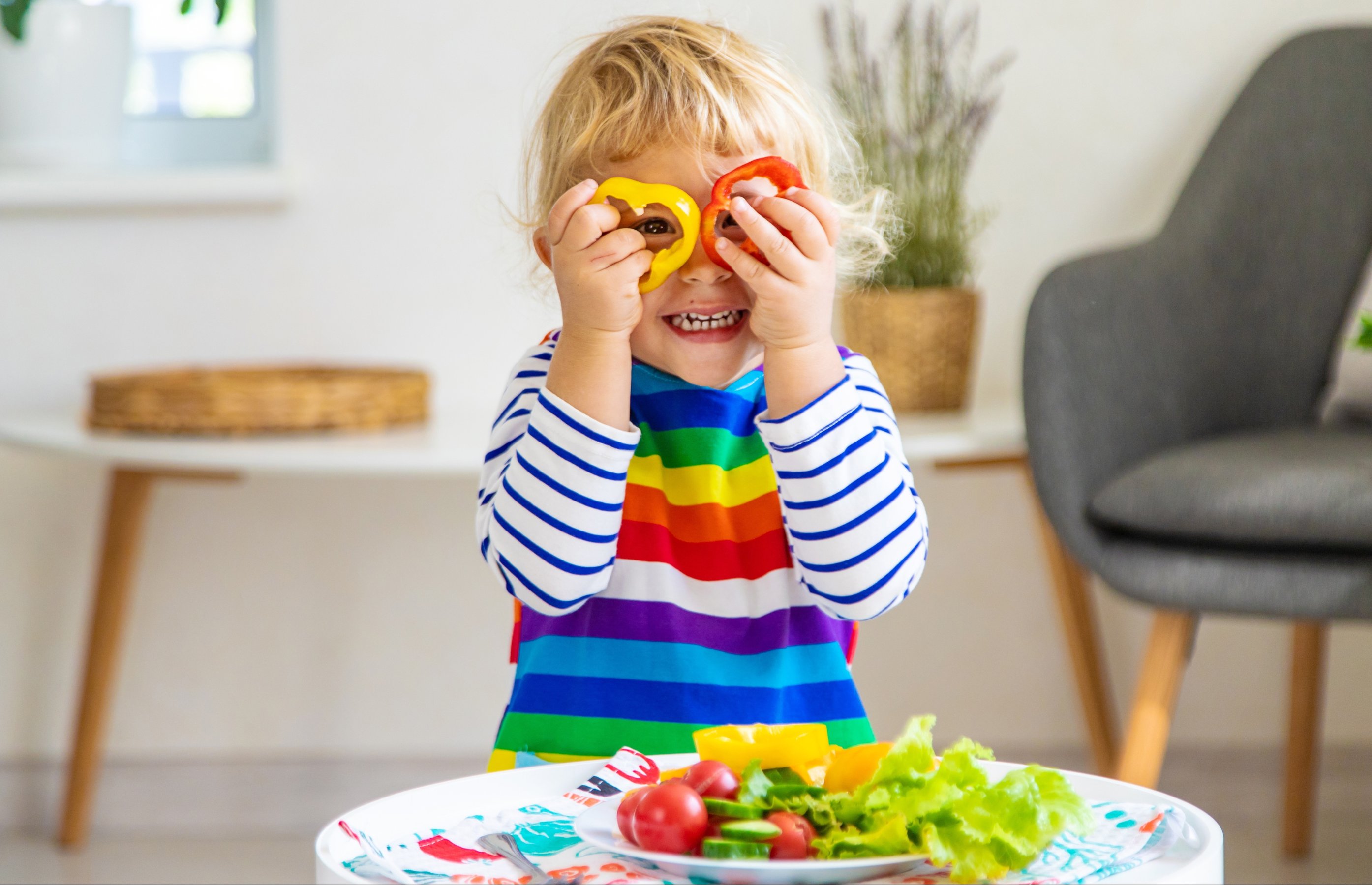 Child eats vegetables at home