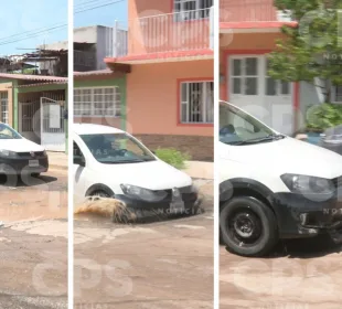 Automóvil cayendo en bache en el Coapinole