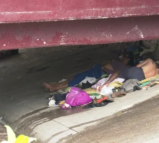 Indigentes durmiendo bajo puente