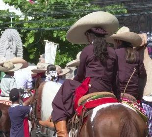 Niñas vestidas de charro montadas en caballos