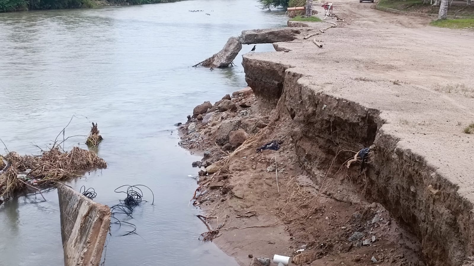 Mitad de la calle consumida por el río Pitillal