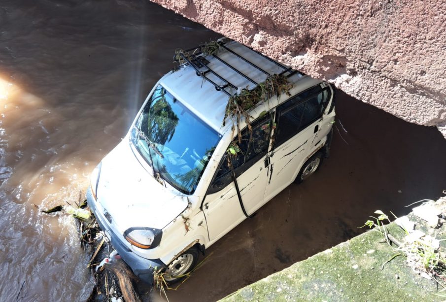 carro arrastrado por aguas del canal