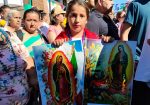 Niña con imagenes de la virgen de Guadalupe