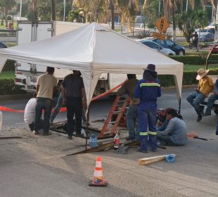 Trabajadores en reparación de alcantarilla rota