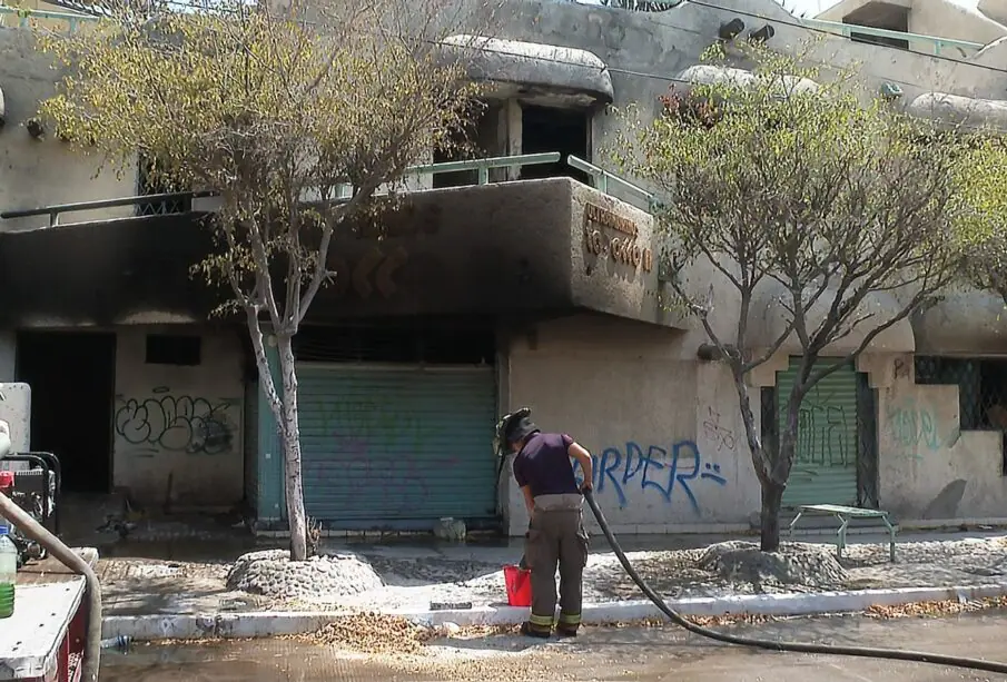 Bomberos apagando incendio en establecimiento abandonado