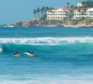 Surfistas en playa Costa Azul.