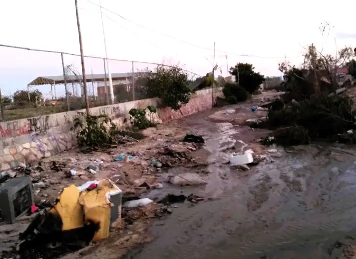 Camino colindante con primaria con corrida de aguas negras