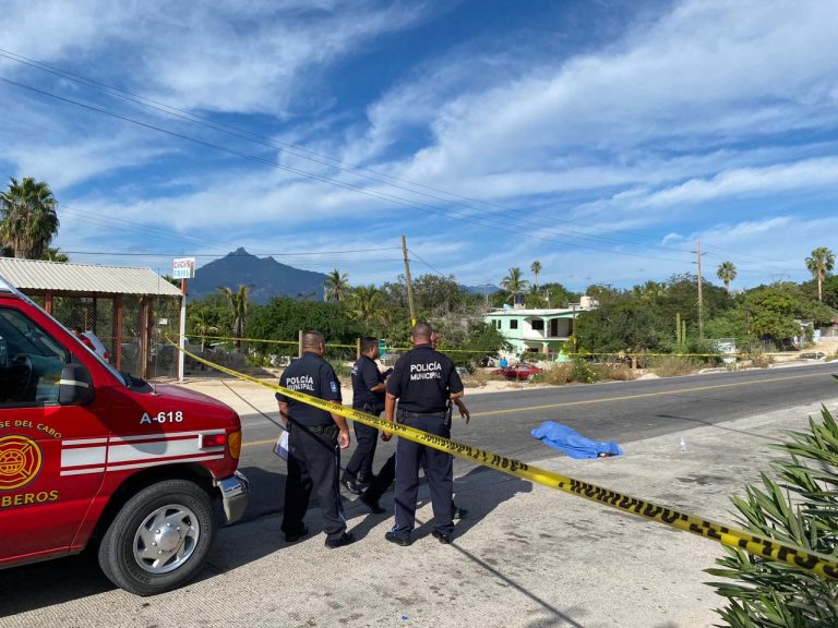 Cuerpo en el carretera cubierto con sabana y zona acordonada con policias