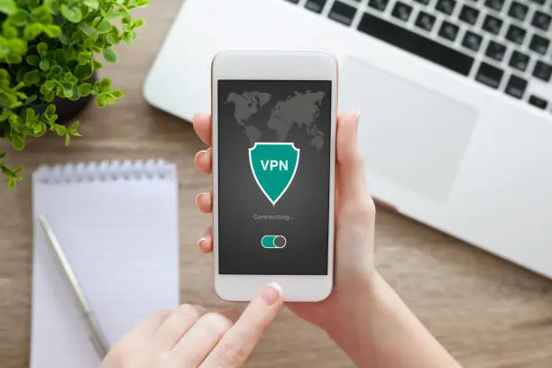 woman holding phone with app vpn creation Internet protocols for protection private network