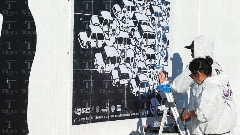 Artistas haciendo mural contra contaminación vehicular