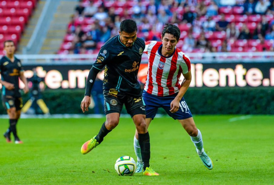 Jugadores del Atlético y Chivas disputando balón