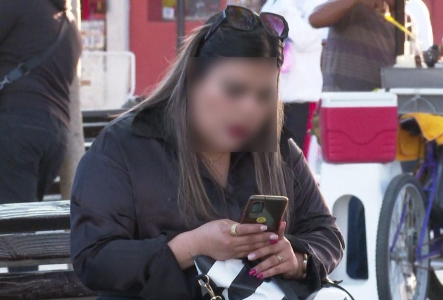 Mujer usando su celular en la calle