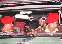 Javed Iqbal taken away by army officials.  AFP