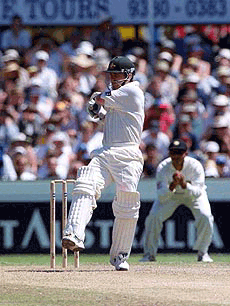 Australia's Justin Langer plays a shot on his way to the first century in the year 2000 during the third cricket test match against India in Sydney on Monday