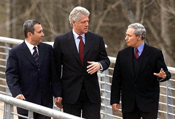 President Clinton speaks with Israeli Prime Minister Ehud Barak (left) and Syrian Foreign Minister Farouq al-Sharaa prior to the start of the West Asia peace talks at the National Conservation Training Centre in Shepherdstown on Monday