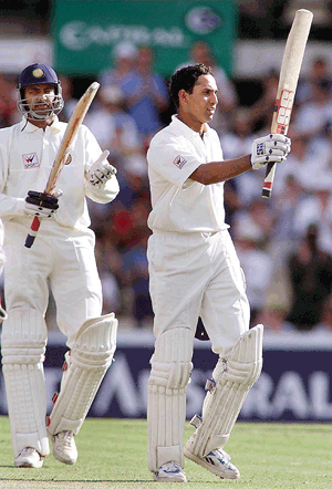 Indian batsman Venkat Laxman (right) acknowledges the applause after scoring his maiden test century