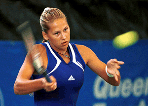Russian drawcard Anna Kournikova has perfect balance as she plays a forehand shot in her match at the Australian Women's Hardcourt Championships Gold Coast on Tuesday against German player Jana Kandarr. Kournikova won the first set 6-1 before Kandarr withdrew in the second round with a thigh strain
