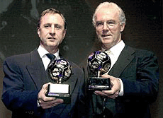 Former Dutch national soccer player Johan Cruyff (left) and former German national soccer star Franz Beckenbauer (right) display the trophies they received during the World Football Gala 2000 in Rothenburg/Fulda, Germany on Tuesday