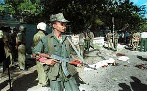 A soldier stands guard outside the Prime Minister's office at the site of the bomb blast in Colombo on Wednesday.