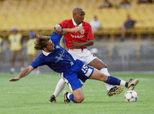 Quinton Fortune of England's Manchester United team fights for the ball against Goren Lozanovski of Australia's South Melbourne team during a game of the First FIFA World Club Championship at the Maracana stadium in Rio de Janeiro, Brazil on Tuesday