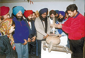 Popular Punjabi pop singer Harbhajan Mann having a try at a maddani shown in an exhibition of Sukhpal Singh in Patiala on Friday