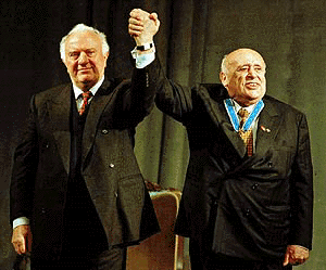Georgia President Eduard Shevardnadze, left, congratulates Turkish President Suleyman Demirel after presenting him with the Georgian order of Golden Fleece in Tbilisi, on Friday. Suleyman Demirel arrived in Georgia on Friday for two days of meetings with his Georgia counterpart in a summit expected to focus on Russia's war in Chechnya and a key oil pipeline that would bypass Russia