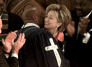 US First Lady Hillary Rodham Clinton is greeted by the Rev. Reginald Williams of the Charity Baptist Church before delivering her speech at the Convent Avenue Baptist Churchs Martin Luther King Jr. celeration function on Monday in New York
