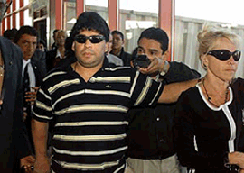 Diego Maradona (left) arrives at the Havana airport on Tuesday, with his wife, Claudia Villafane. The former Argentine soccer star arrived Tuesday morning in Cuba to be treated for drug abuse after a hospitalization that was brought on by cocaine use. 