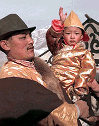 The seventh Reting Lama waves to people on his way from Lhasa to Reting monastery in central Tibet on Friday