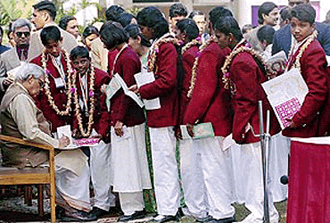 Prime Minister A. B. Vajpayee giving autographs to the receipients of the national award for bravery-1999 after the award presentation ceremony at his residence in New Delhi on Monday