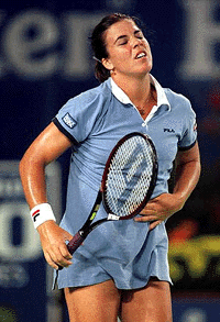 American Jennifer Capriati from Saddlebrook, Fla., presses her stomach in pain during her match against Ai Sugiyama from Japan at the Australian Open Tennis Championships in Melbourne, Australia on Tuesday