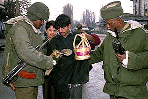 Indian troopers search local residents in downtown Srinagar during a security check ahead of the nation's 50th Republic Day celebrations. Islamic separatist organisations have vowed to disrupt the yearly celebrations, amidst a surge in militant activity in the troubled region of Kashmir