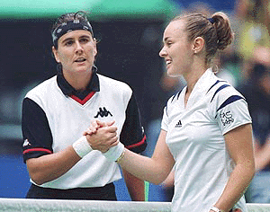 MELBOURNE : Martina Hingis from Switzerland on right shakes hands with Conchita Martinez from Spain after her center court semi-final victory by 6-3, 6-2, over at the Australian Open Tennis Championships in Melbourne, Australia on Thursday