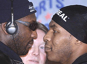 American Boxer Mike Tyson (right) poses in a head to head with opponent Julius Francis in the centre of Manchester, England on Thursday, prior to their heavyweight bout Saturday