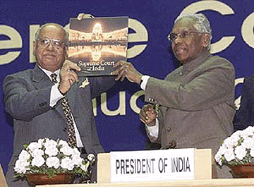 President K. R. Narayanan being presented with a book on Supreme Court by Chief Justice of India A. S. Anand at the golden jubilee celebrations of Supreme Court of India at a function in New Delhi on Friday