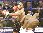 Mike Tyson of the United States (left) swings wildly at Britain's Julius Francis during their heavyweight boxing fight at the MEN Arena in Manchester, England, Saturday