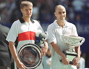 Runner up Yevgeny Kafelnikov of Russia (left) and American Andre Agassi from Las Vegas, hold their trophies after mens final at the Australian Open Tennis Championships in Melbourne, on Sunday. Agassi won the match 