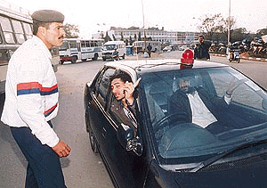 Traffic policemen stop vehicles with red lights atop to check if the owners have the necessary authorisation near the Sector 17 bus stand roundabout in Chandigarh on Tuesday 