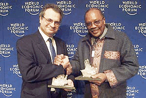 Composer Quincy Jones (right) and French author Amin Maalouf, pose with their Crystal Awards at the end of the World Economic Forum in Davos, Switzerland on Tuesday. The Crystal Awards honour artists who have used their art as a means to reach out to other cultures