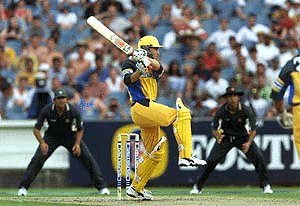 Australian batsman Michael Bevan follows his shot during the first of the best of three finals series cricket matches between Australia and Pakistan at the Melbourne Cricket Ground on Wednesday